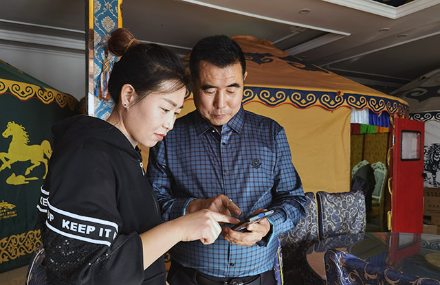 勞動保障協(xié)理員深入餐飲企業(yè)宣講技能培訓政策，面對面講解中式面點師培訓內容和報名流程。（攝影：王海霞）