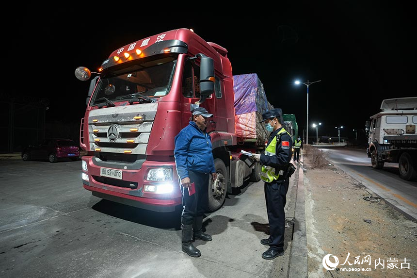 二連出入境邊防檢查站移民管理警察正在查驗貨車司機通關證件。郭鵬杰攝